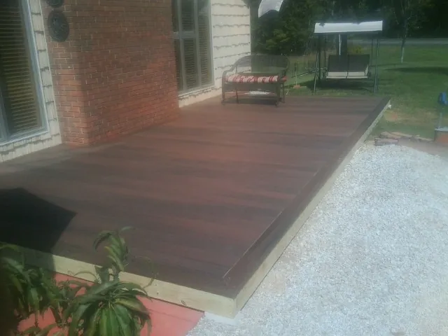 Freshly stained wood deck built against a brick home in Osage Beach
